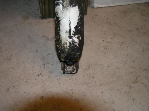 2000 Ford Excursion - Close-up of a dirty shock absorber, likely from a vehicle's suspension system.