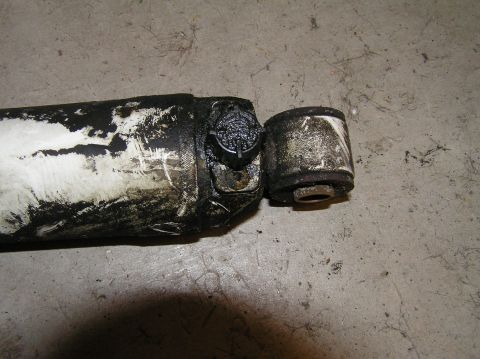 2000 Ford Excursion - A close-up view of a used shock absorber, showing wear and dirt accumulation.