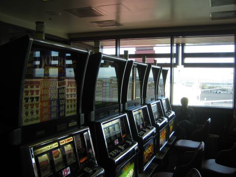 1968 Ford Mustang - Slot machines are lined up inside a casino with a view of the outside.