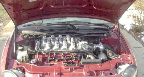 1997 Ford Taurus - Engine bay view of a 1997 Ford Taurus, showing the V6 engine and intake system.