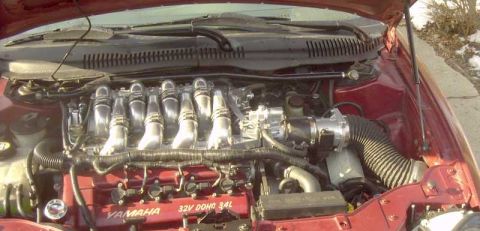 1997 Ford Taurus - Close-up of a vehicle's engine bay, highlighting the Yamaha 32V DOHC 3.4L engine.
