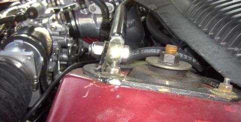 1997 Ford Taurus - Close-up view of engine bay components, including hoses and air intake assembly.