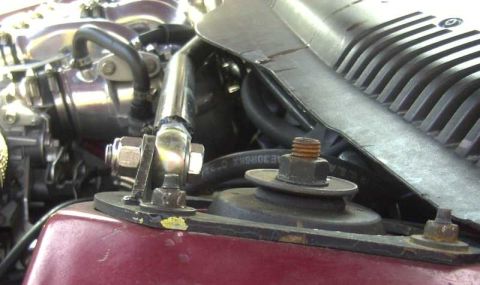 1997 Ford Taurus - Close-up view of engine components, including hoses and mounting hardware.
