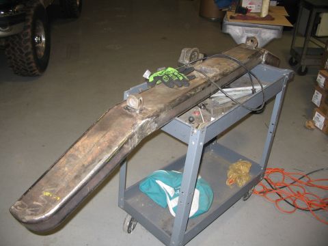 1996 Ford Bronco - A custom fabricated bumper sits on a utility cart in a workshop setting.