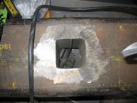 1996 Ford Bronco - Close-up of a modified metal bumper section with a visible internal component and grinding marks.