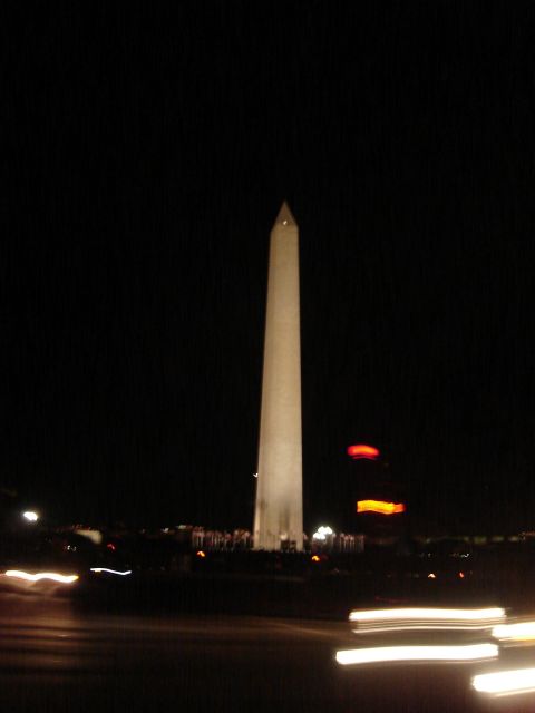 1994 Ford Bronco - The Washington Monument is illuminated against the night sky, with blurred car lights in the foreground.