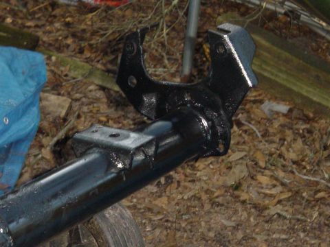 1989 Ford Bronco - Close-up of a painted suspension part, likely from a vehicle's drivetrain.