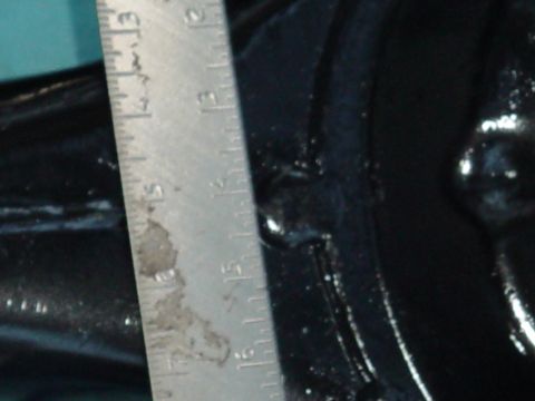 1989 Ford Bronco - A ruler is used to measure a component, possibly a differential housing, in this close-up shot.