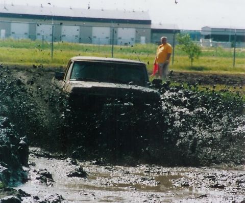1979 Ford F-250 - This 1979 Ford F-250 navigates a challenging mud bog, sending spray high into the air.