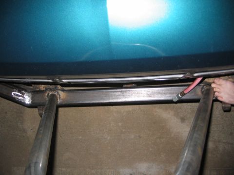 1996 Ford Bronco - Custom bumper fabrication is underway, showing metalwork and a red hose near the vehicle's underside.