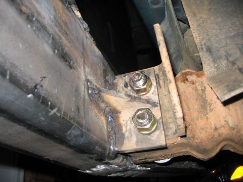 1996 Ford Bronco - Close-up of a custom bumper mounting bracket, showing welded seams and heavy-duty bolts.