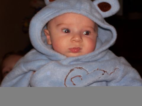 1986 Ford Bronco - A baby dressed in a blue bear costume with ears on the hood.