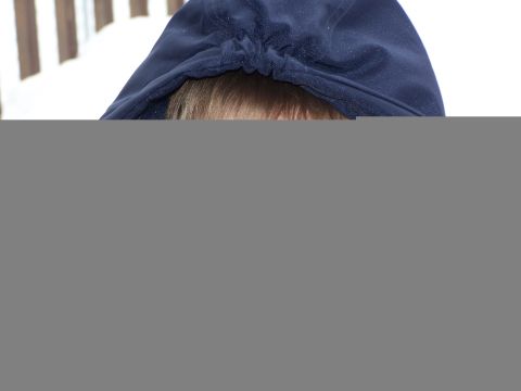 1986 Ford Bronco - A child's face is obscured by a dark blue hood, with a hint of blonde hair showing.
