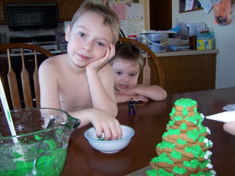 1986 Ford Bronco - Two young boys are at a table, one is decorating a gingerbread tree while the other watches.