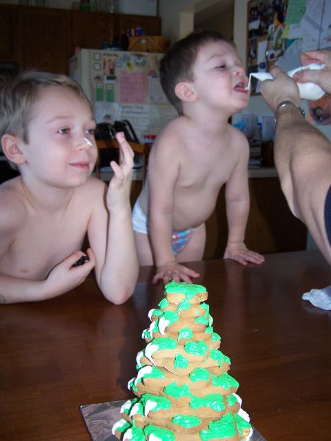 1986 Ford Bronco - A boy is being given something from a white container while his brother watches, with a decorated cookie tree in the foreground.