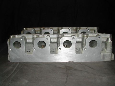 1971 Ford Mustang - Engine cylinder heads are shown in this close-up view against a dark background.