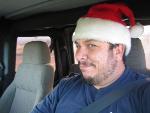 1968 Ford Mustang - Man in Santa hat driving a vehicle, with passenger seat visible.