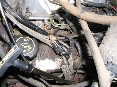 1990 Ford Bronco - Close-up view of an engine bay, showing various components and wiring harnesses.