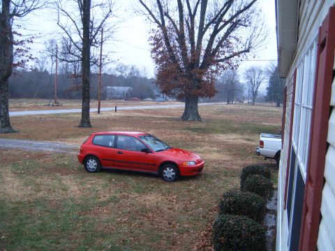 1988 Ford Bronco - Red 1992 Honda Civic hatchback parked outside a house on a cloudy day.