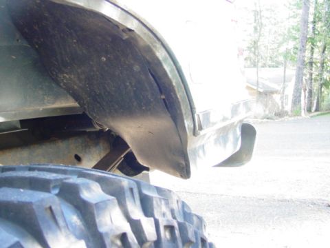 1986 Ford Bronco - Close-up view of a vehicle's fender wall and tire, with a portion of the body visible.