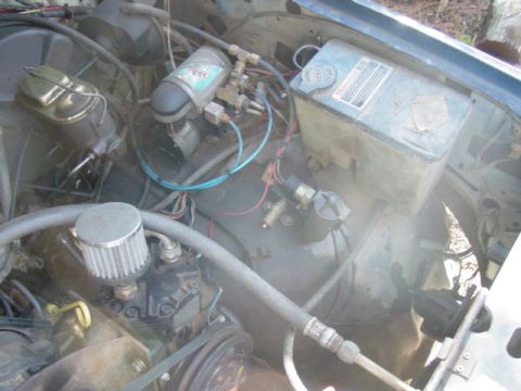 1986 Ford Bronco - Engine bay components including an air compressor and brake fluid reservoir are visible.