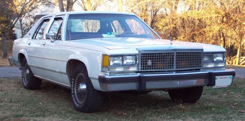 1985 Ford Crown Victoria LTD - This sedan has a distinctive grille and chrome trim, with a license plate on the front bumper.