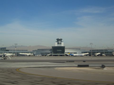 1968 Ford Mustang - View of an airport terminal and control tower with several airplanes at the gates.