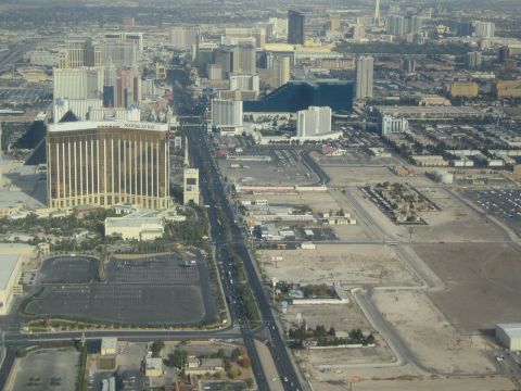 1968 Ford Mustang - An aerial perspective captures the bustling Las Vegas Strip, highlighting iconic hotels and the flow of traffic.