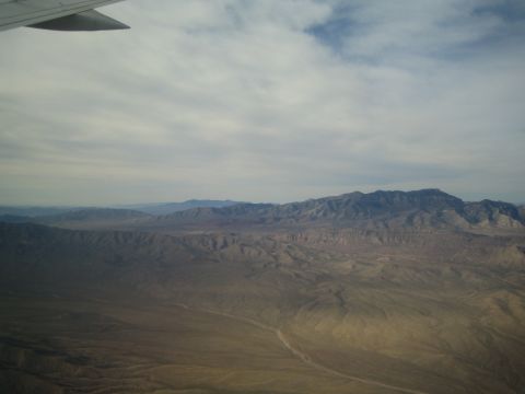 1968 Ford Mustang - Aerial view of a desolate mountain landscape under a cloudy sky.