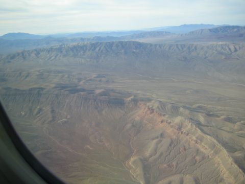 1968 Ford Mustang - The vast, terrain stretches out below, seen from the perspective of an aircraft.