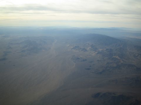 1968 Ford Mustang - An aerial perspective reveals a desert terrain under a cloudy sky.