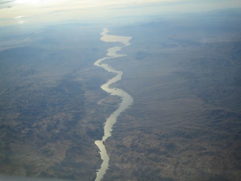 1968 Ford Mustang - A river snakes through a vast desert landscape as seen from above.