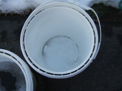 1998 Ford Taurus - Two buckets are shown outdoors, one containing soapy water, with snow visible in the background.