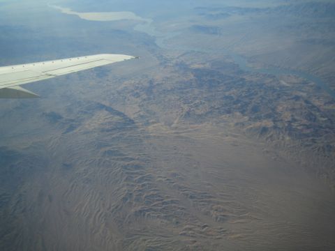1968 Ford Mustang - Aerial view of a desert landscape with a river, seen from an airplane.