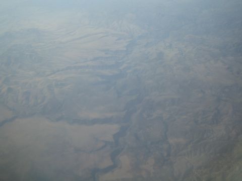 1968 Ford Mustang - An aerial perspective reveals a deep canyon carved into a dry, mountainous landscape.
