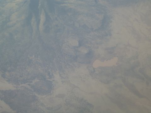1968 Ford Mustang - An aerial photograph captures a vast desert terrain, highlighting a pale, irregular-shaped lake amidst arid land.