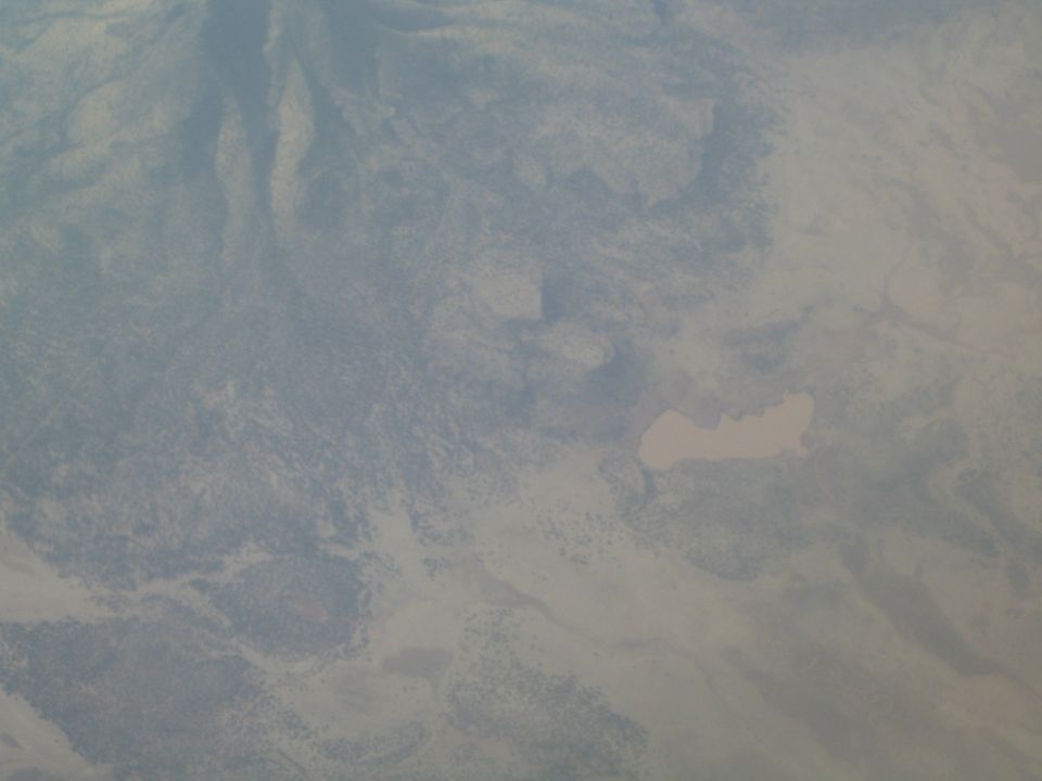 Aerial view of a desert landscape with a light-colored lake
