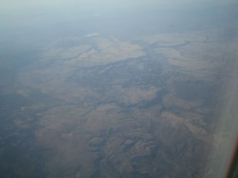 1968 Ford Mustang - Expansive aerial view of a canyon system, showing geological formations and arid terrain.