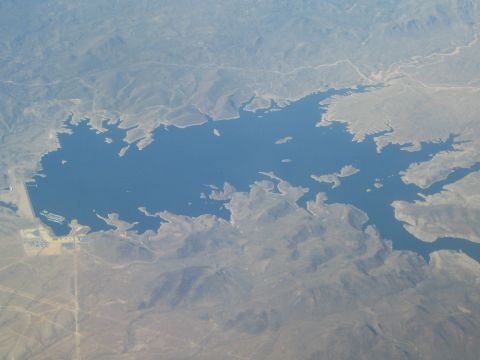 1968 Ford Mustang - An expansive body of water is seen from above, with a large dam structure visible along its edge.