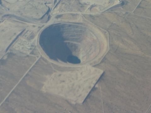 1968 Ford Mustang - An aerial perspective captures the immense scale of an open-pit mine carved into the arid landscape.