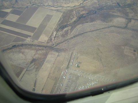 1968 Ford Mustang - An aerial perspective shows numerous aircraft stored in a desert landscape.