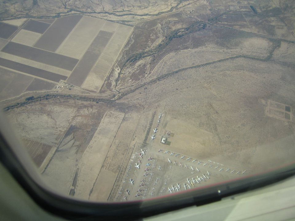 Aerial view of an airplane boneyard with many planes parked in rows