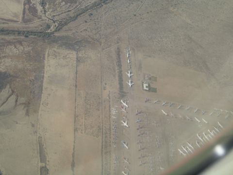 1968 Ford Mustang - An aerial perspective captures numerous airplanes parked in a desert boneyard, awaiting their fate.