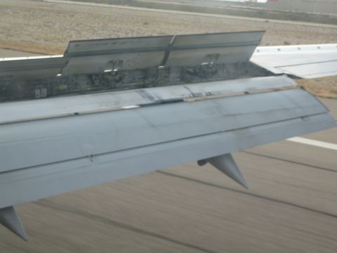 1968 Ford Mustang - View of extended airplane wing flaps during takeoff or landing on a runway.