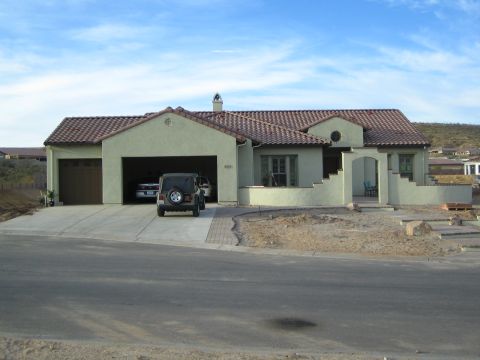 1968 Ford Mustang - A suburban home features a light green facade and a spacious garage, with a Jeep parked outside.
