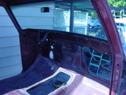 1979 Ford Bronco - The interior of a vehicle is shown, with the dashboard and door frame visible, indicating it is undergoing restoration or disassembly.