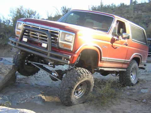 1984 Ford Bronco - This modified Ford Bronco navigates a challenging off-road course.