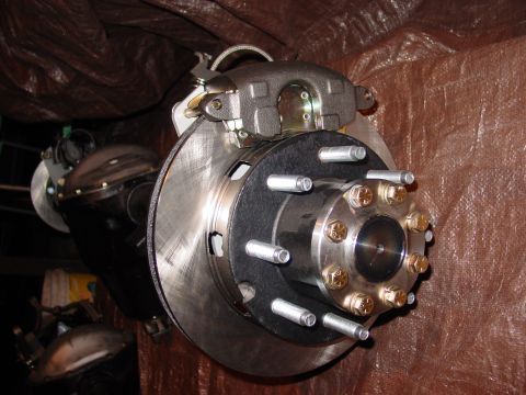 1979 Ford Bronco - This photo shows a vehicle's brake assembly, including the rotor, caliper, and hub with lug nuts.