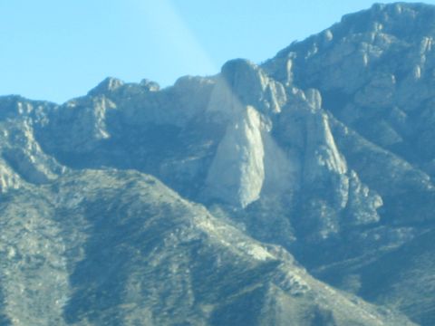1968 Ford Mustang - A scenic view of a mountain range under a bright blue sky, terrain and a distinctive rock spire.