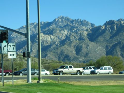 1968 Ford Mustang - Roadside view with Arizona Route 77 sign and vehicles against a mountain backdrop.